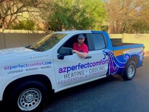 Technician in branded AZ Perfect Comfort truck for residential and commercial heating system installation.