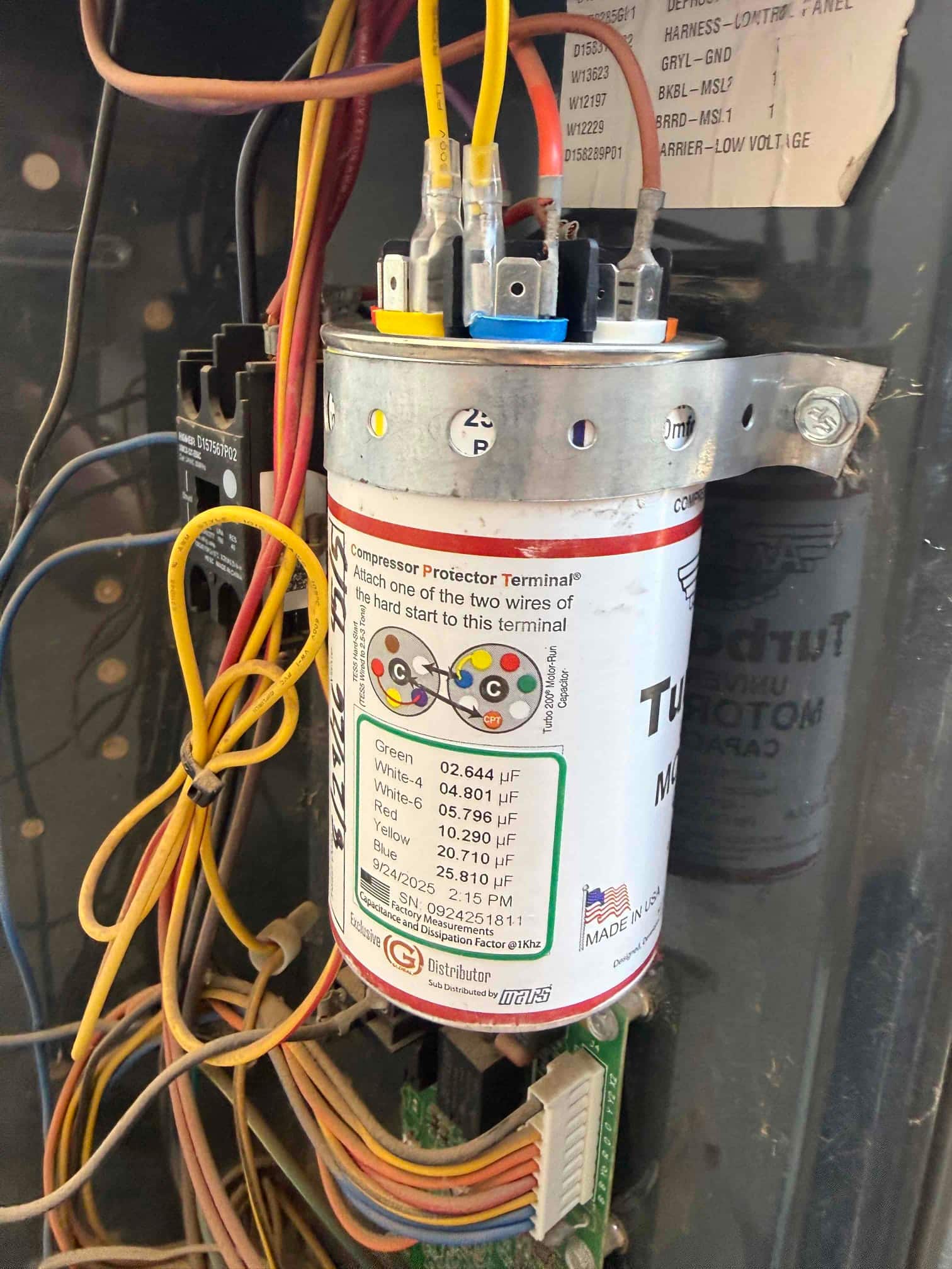 New capacitor installed, rated 20 μF, with clean wire connections to the terminal.