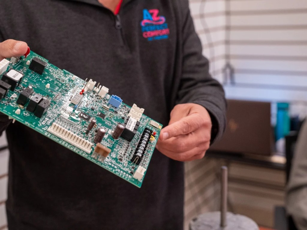 AZ Perfect Comfort technician repairing a residential air conditioner