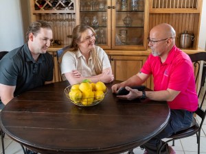 AZ Perfect Comfort advisor explaining repair options to homeowners in their home