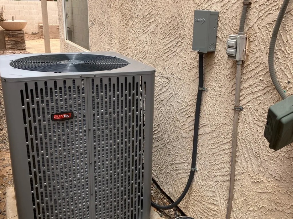 AZ Perfect Comfort technician servicing a central air conditioner