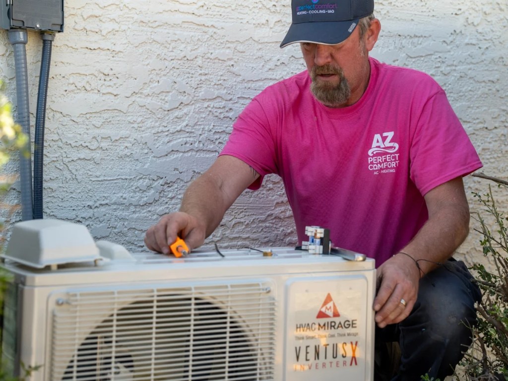 Technician checking an evaporative cooling system