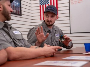 AZ Perfect Comfort technicians discussing equipment during a weekly training meeting