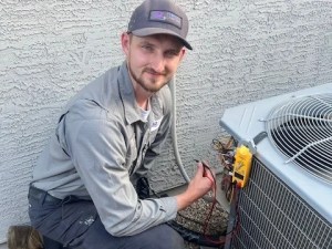 AZ Perfect Comfort technician servicing an outdoor air conditioner condenser