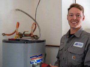 AZ Perfect Comfort technician beside a newly installed residential water heater