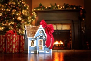 Festively decorated living room with fireplace and miniature house gift, symbolizing new furnace installation.