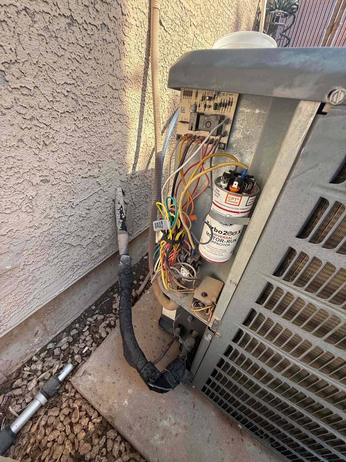 Condenser fan motor and capacitor removed, showing wiring and connections for replacement.