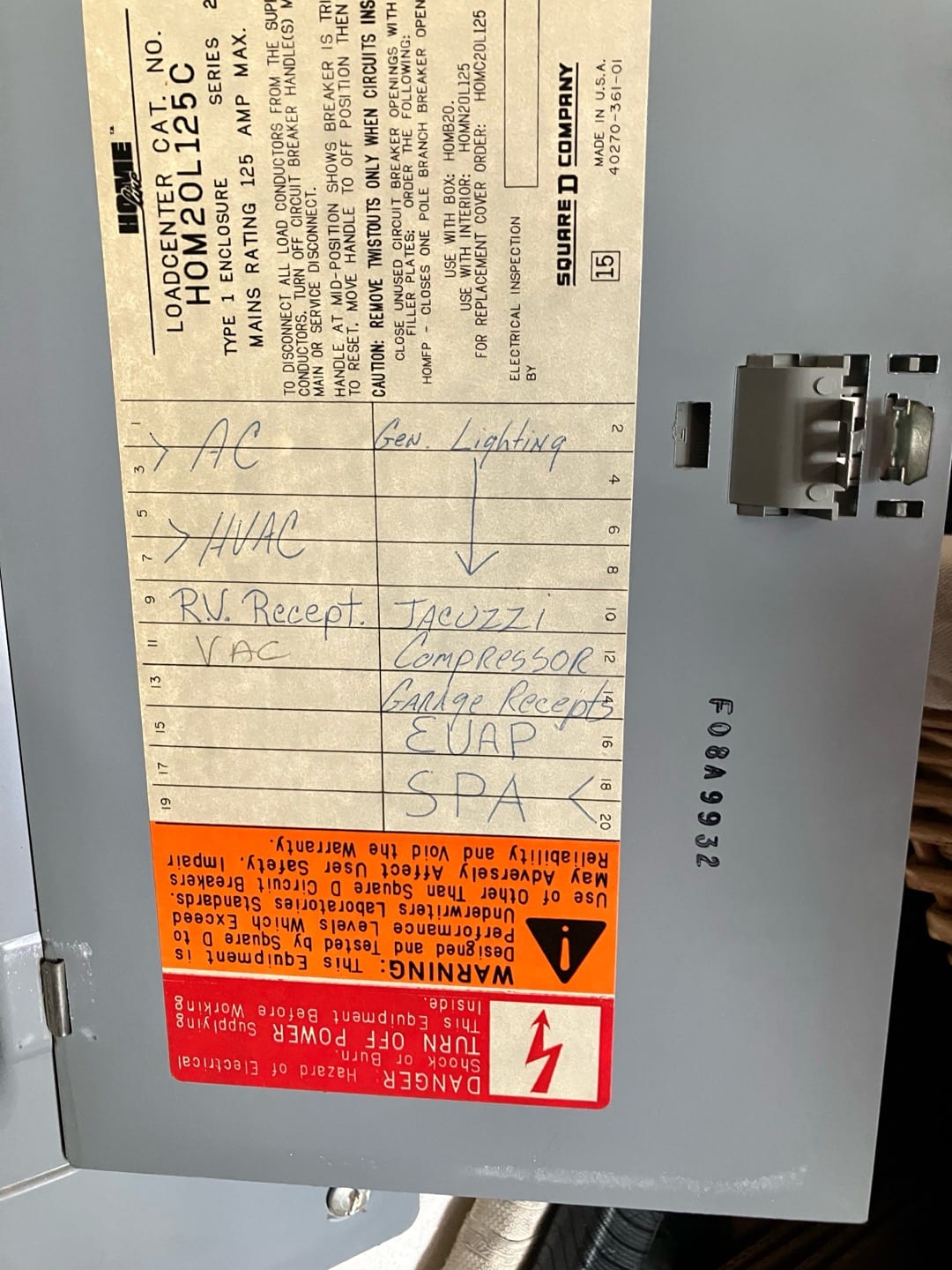 Breaker panel door label shows circuit directory entries including AC, HVAC, compressor, and evaporator, with safety warnings and manufacturer information.
