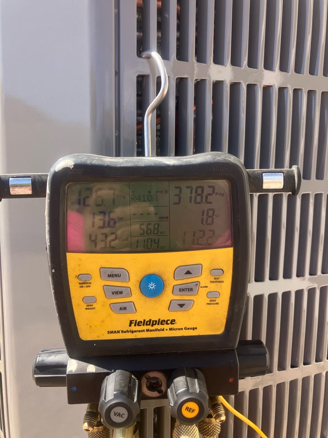Digital manifold on condenser shows 126 PSI suction and 378 PSI liquid with refrigerant type indicated on the display.
