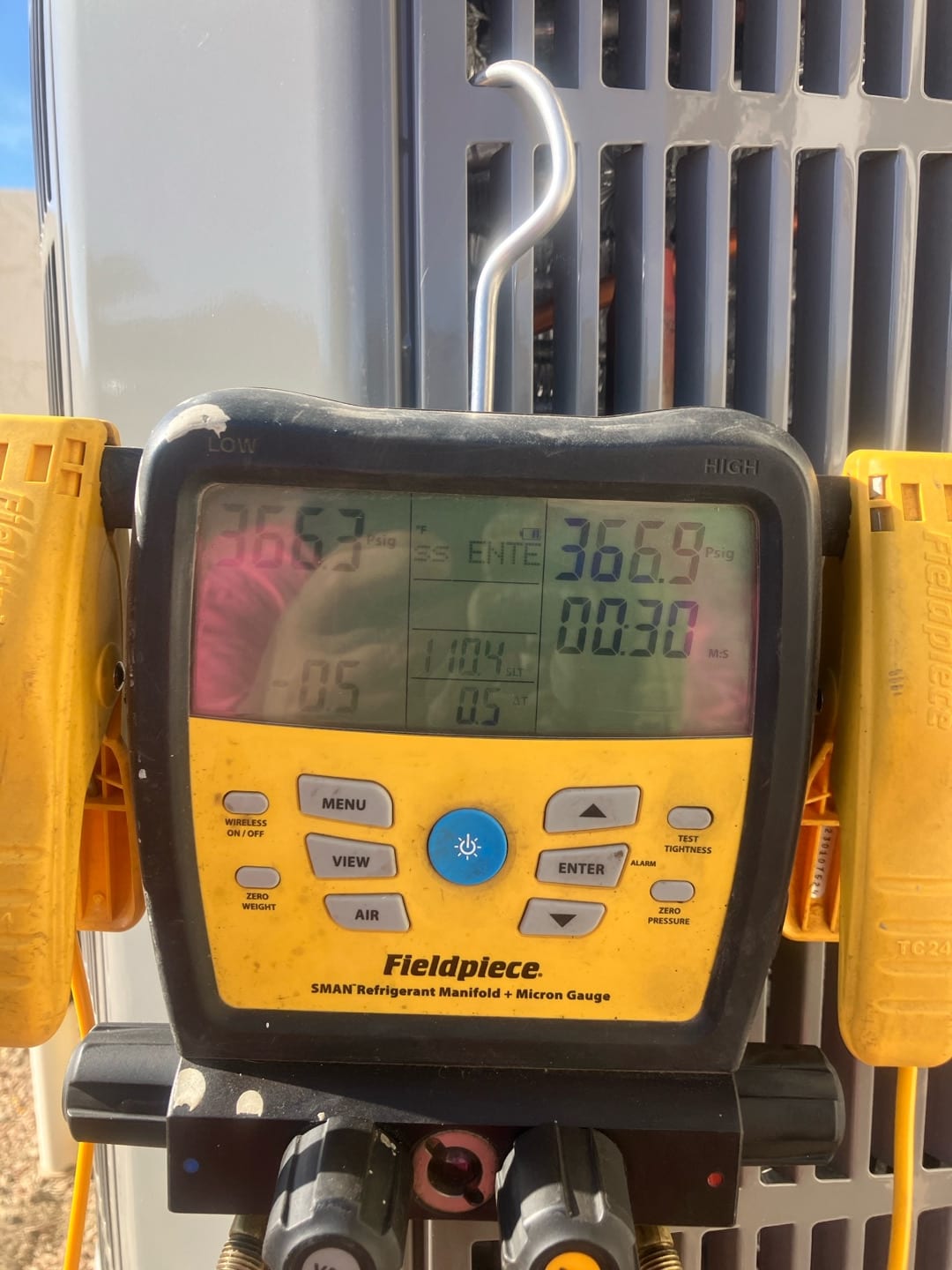 Digital manifold shows equal pressures near 367 PSI on both sides during a nitrogen pressure test at the outdoor unit.
