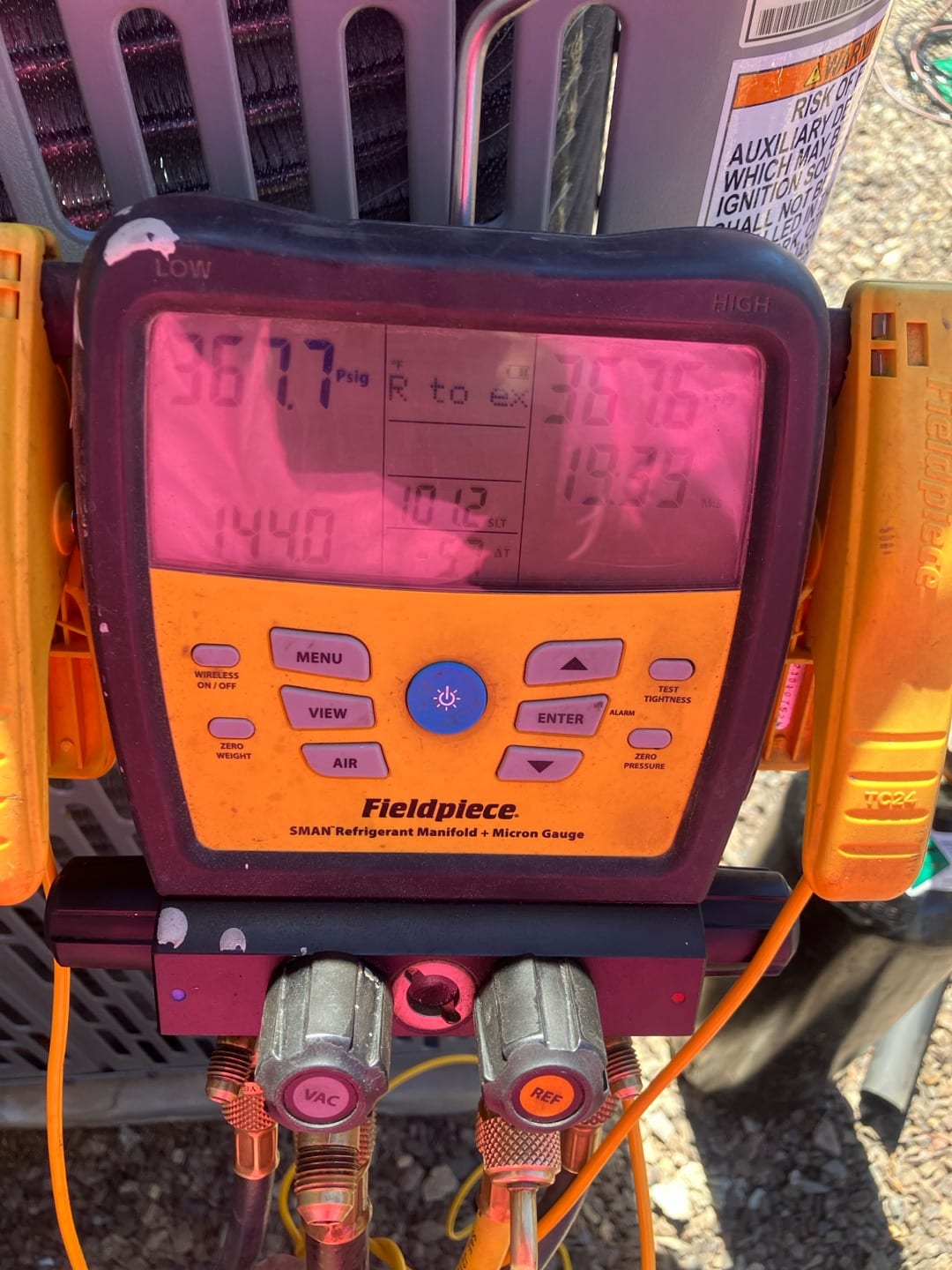 Digital manifold shows equal pressures on both sides around 367 PSI during a nitrogen pressure test at the outdoor unit.