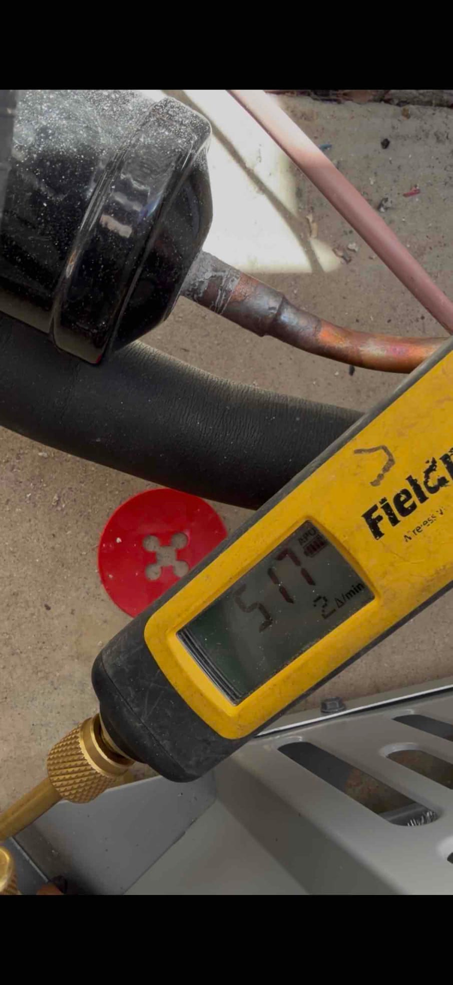 Micron gauge connected at the outdoor unit displays 517 microns during evacuation of the new heat pump system.