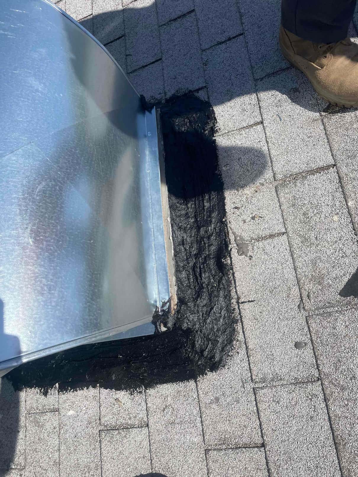 Roof duct curb is sealed with roofing mastic around the sheet metal penetration to ensure a weather-tight installation.