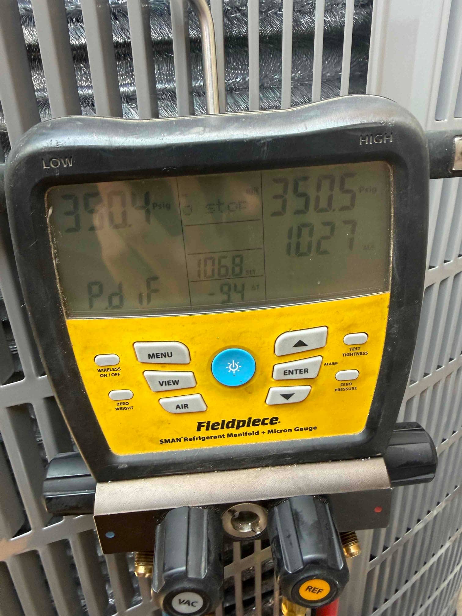 Digital manifold shows equalized pressures around 350 PSI on both sides during a nitrogen pressure test at the outdoor unit.