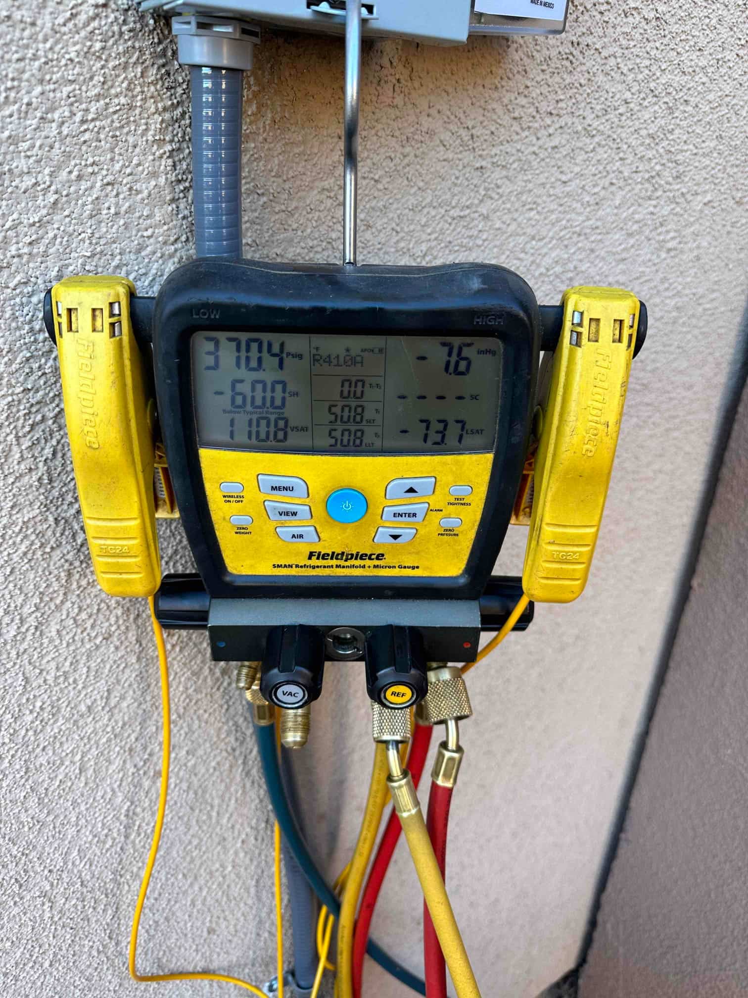 Digital manifold shows both sides holding 370 PSI during a nitrogen pressure test of the installed system.
