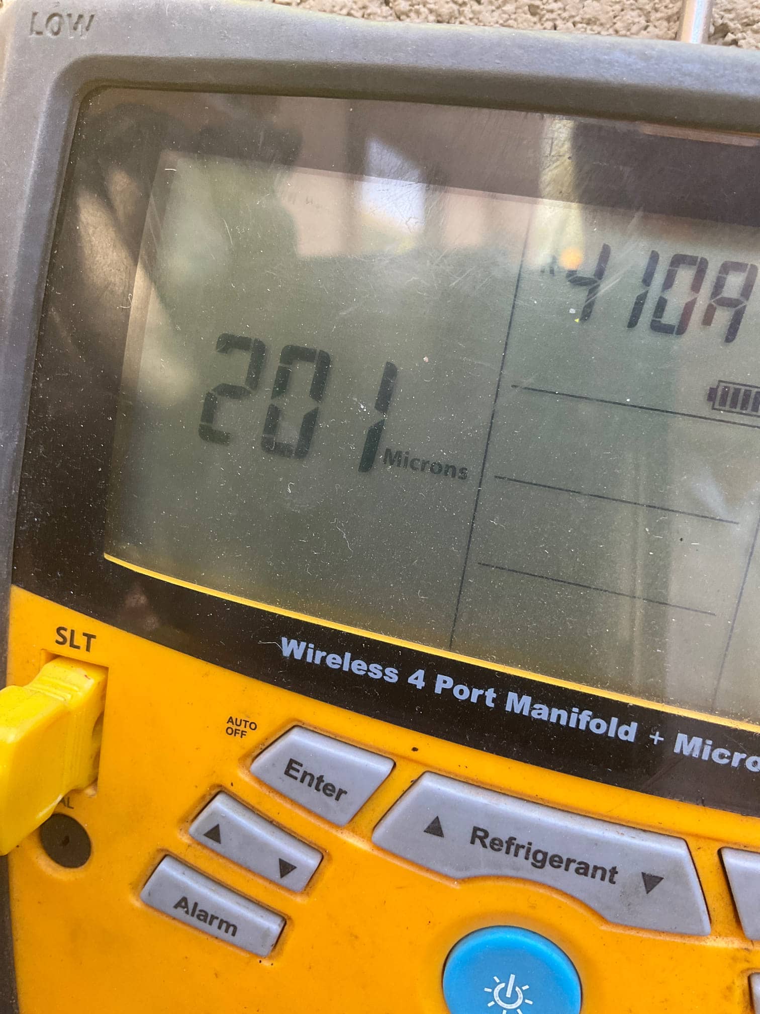 Digital micron display reads 201 microns on the manifold during system evacuation before releasing refrigerant charge.
