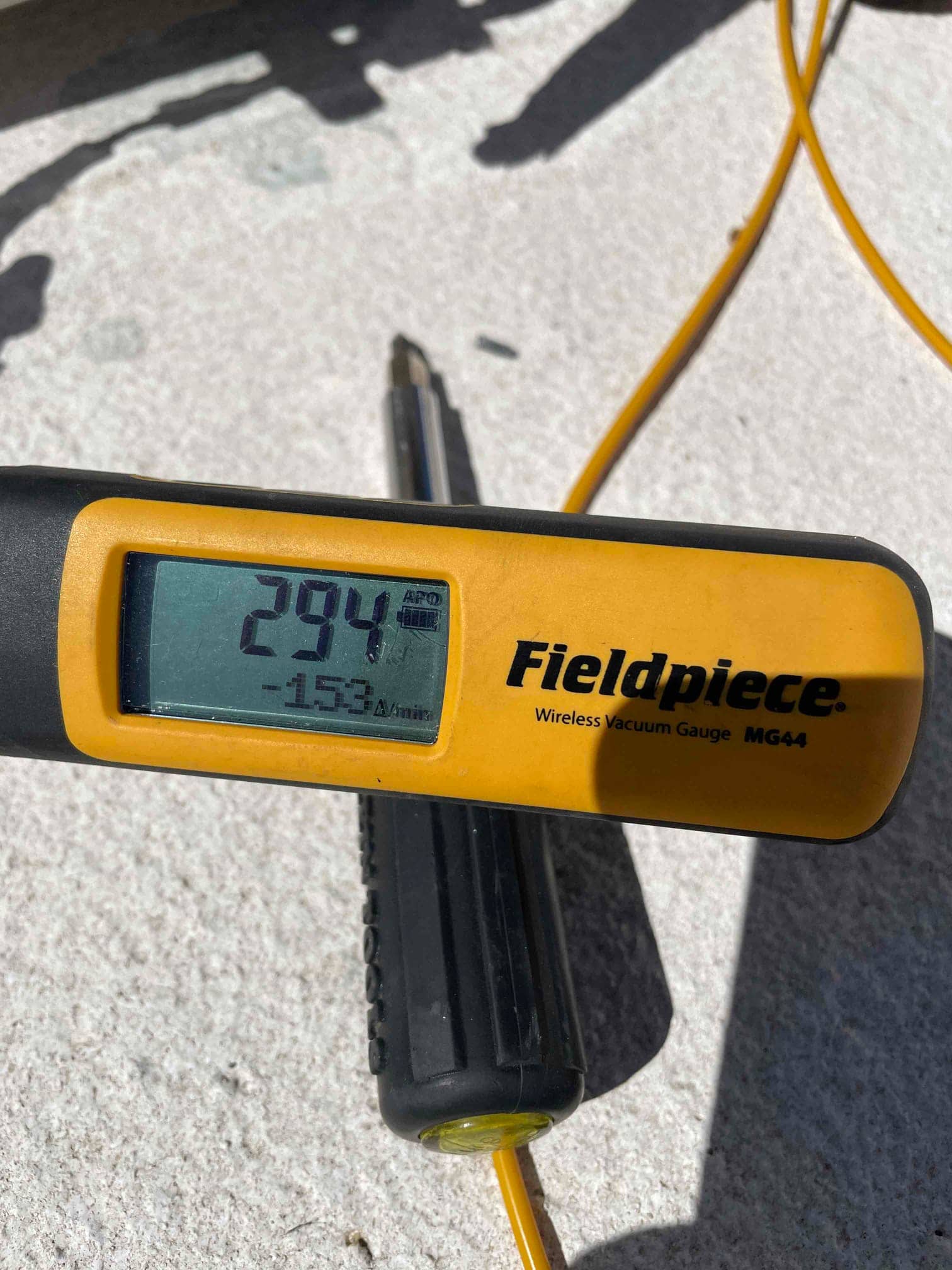 Digital vacuum gauge shows 294 microns during the evacuation phase prior to releasing refrigerant into the system.