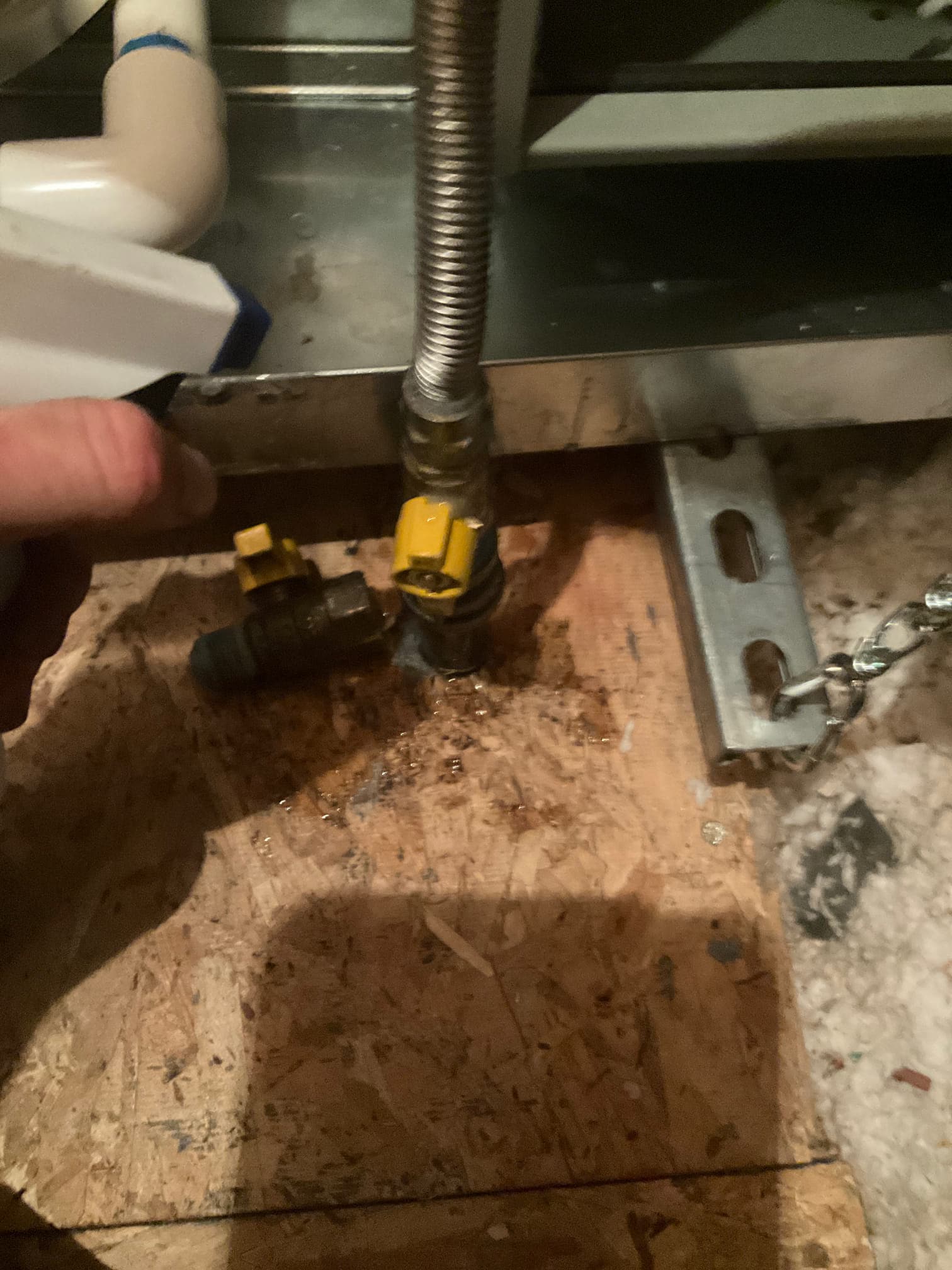 Gas flex connector and shutoff valves at the furnace, with leak detection solution being applied to check fittings.