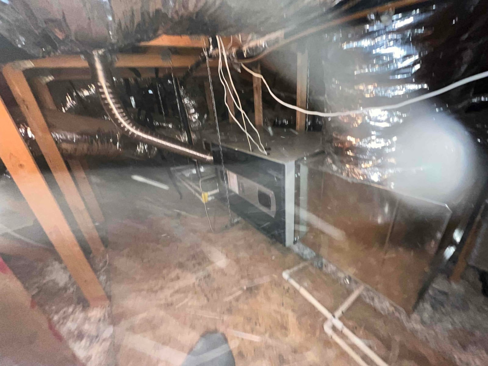 New air handler and duct transitions installed in the attic with insulated flex ducts and PVC condensate drain piping visible.