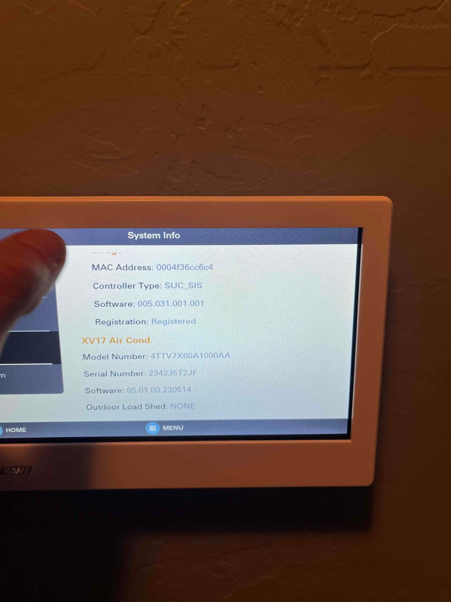 Thermostat system info screen displays controller details and connected air conditioner model and serial information after installation.