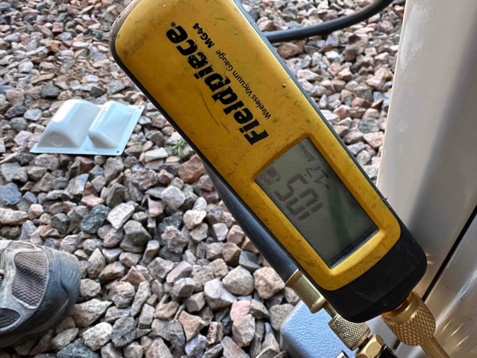 Wireless vacuum gauge shows a deep system vacuum during evacuation prior to refrigerant charging.