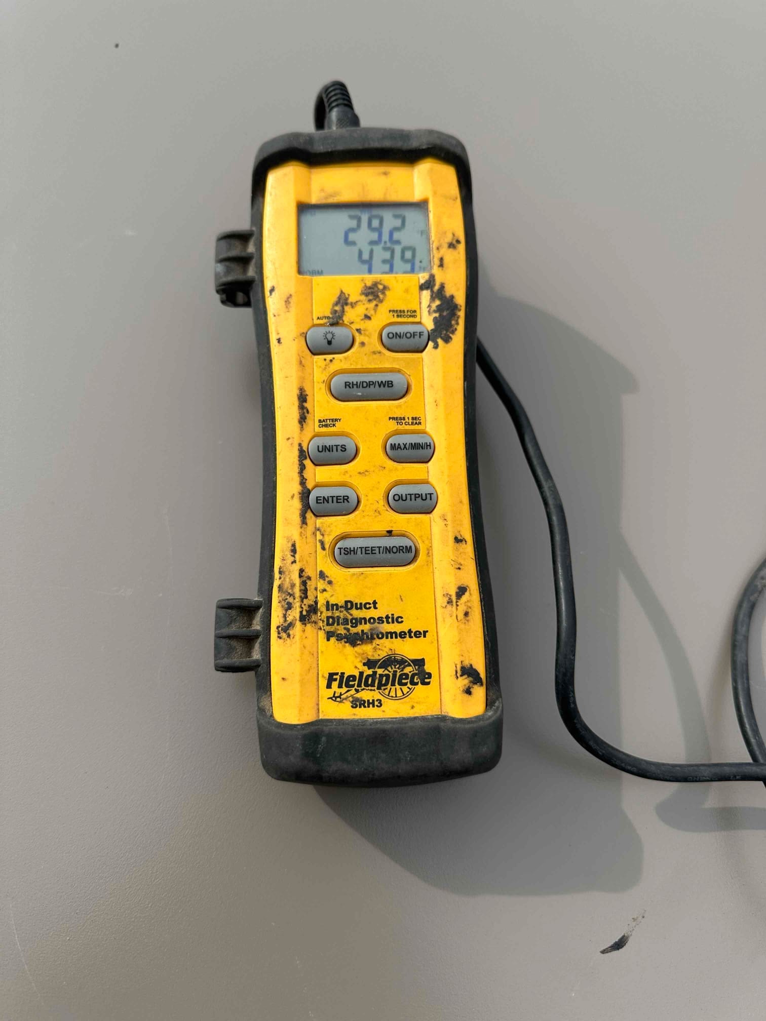 Digital in-duct diagnostic psychrometer displaying readings 29.2 and 43.9 during air-side measurements on the new system.