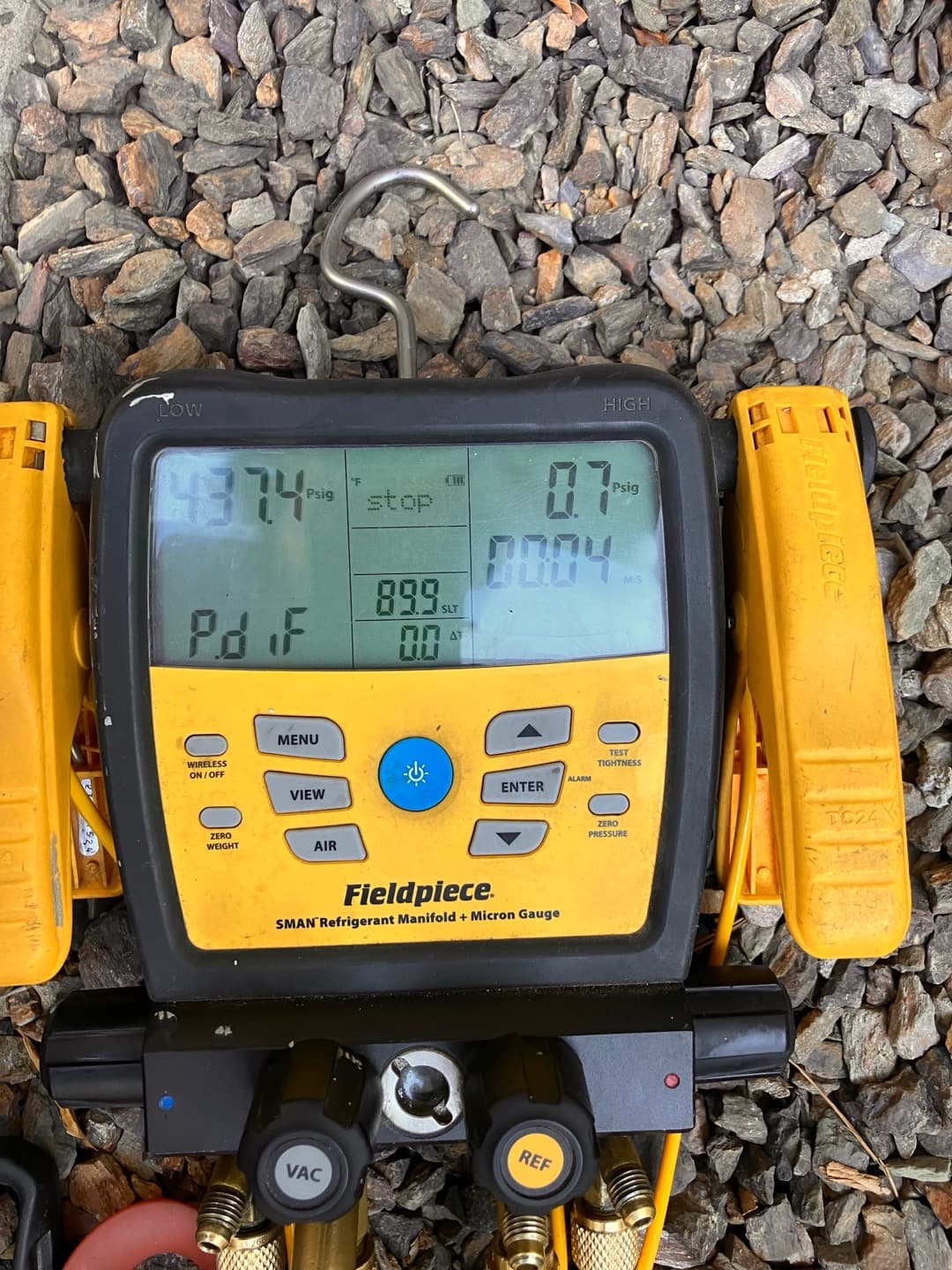 Digital manifold gauge set shows system operating with split pressures while connected to the newly installed HVAC system.