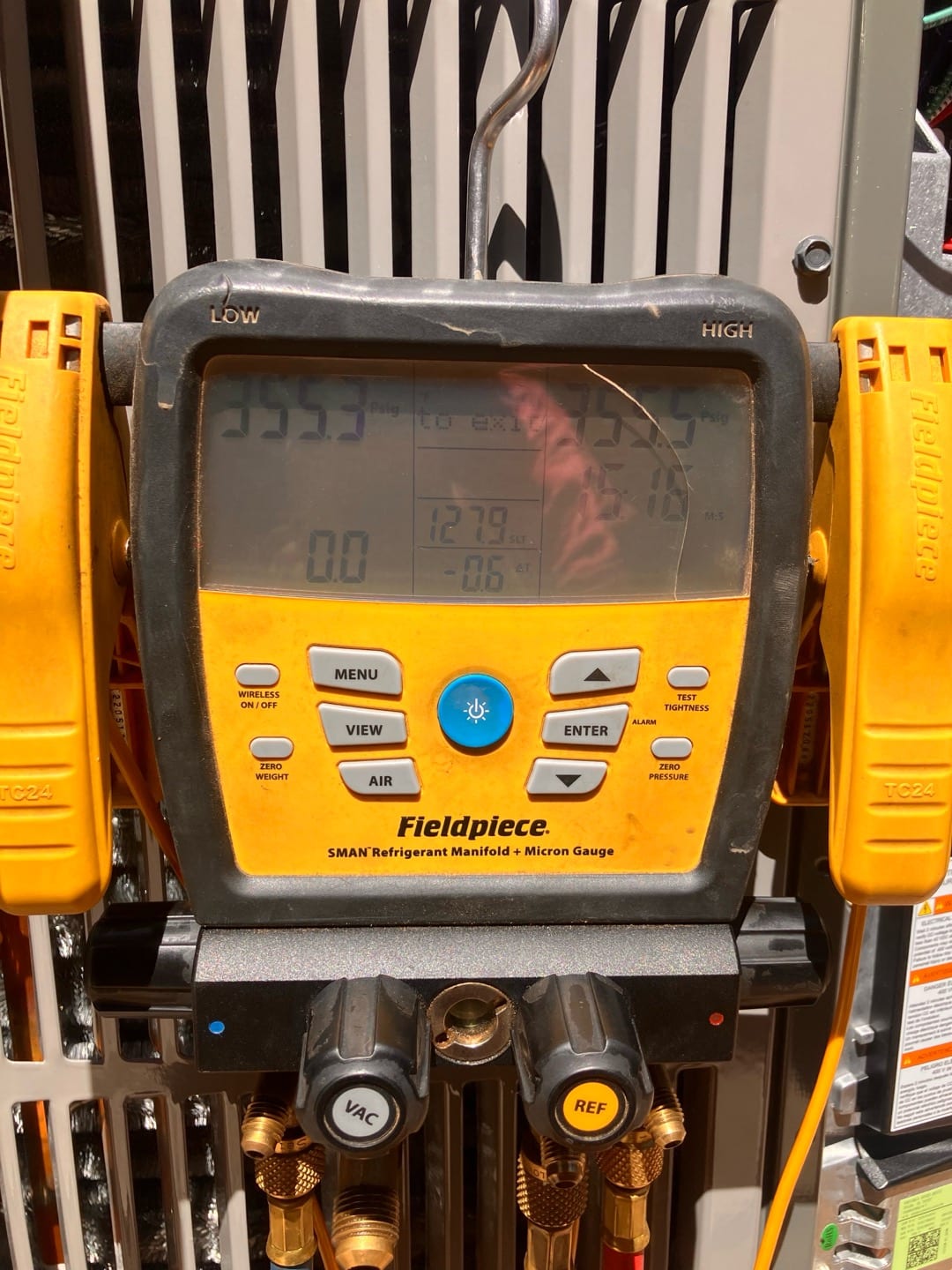 Digital manifold shows equal high pressures on both sides during a nitrogen pressure test at the outdoor unit.