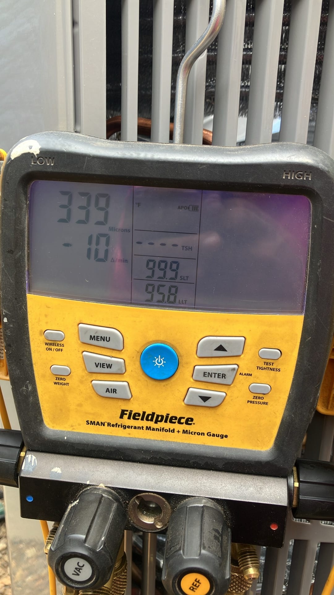 Digital manifold shows both high and low sides holding 339 PSI, documenting a nitrogen pressure test on the new system.