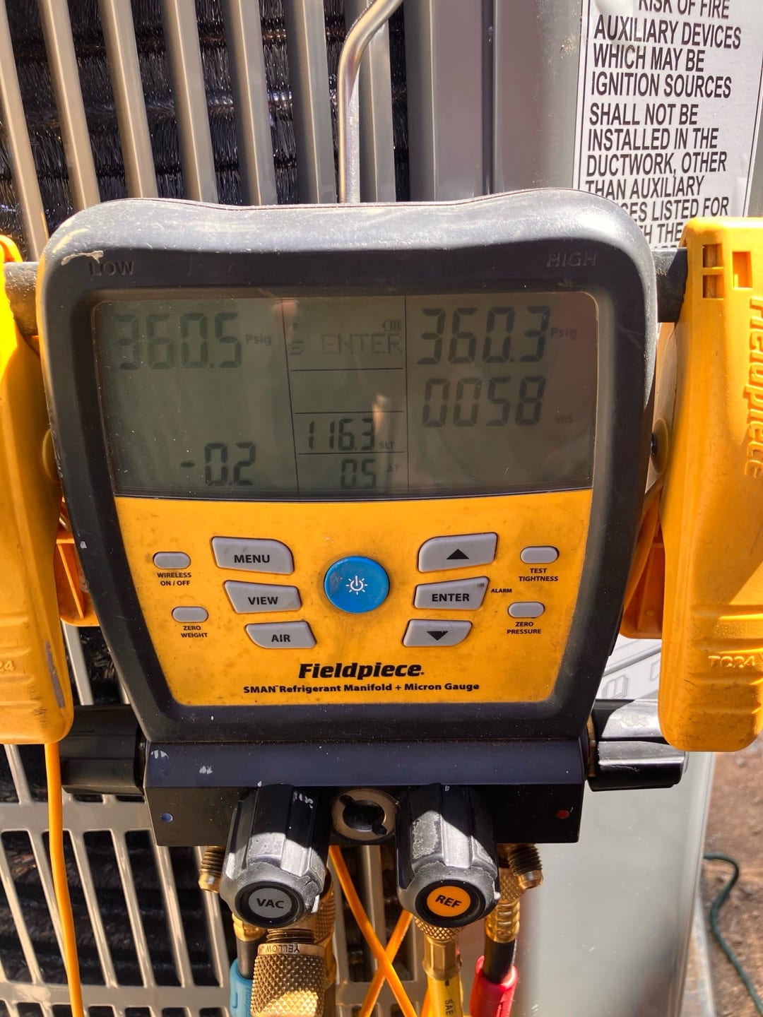 Digital manifold shows both high and low sides holding around 360 PSI, documenting a nitrogen pressure test on the new system.