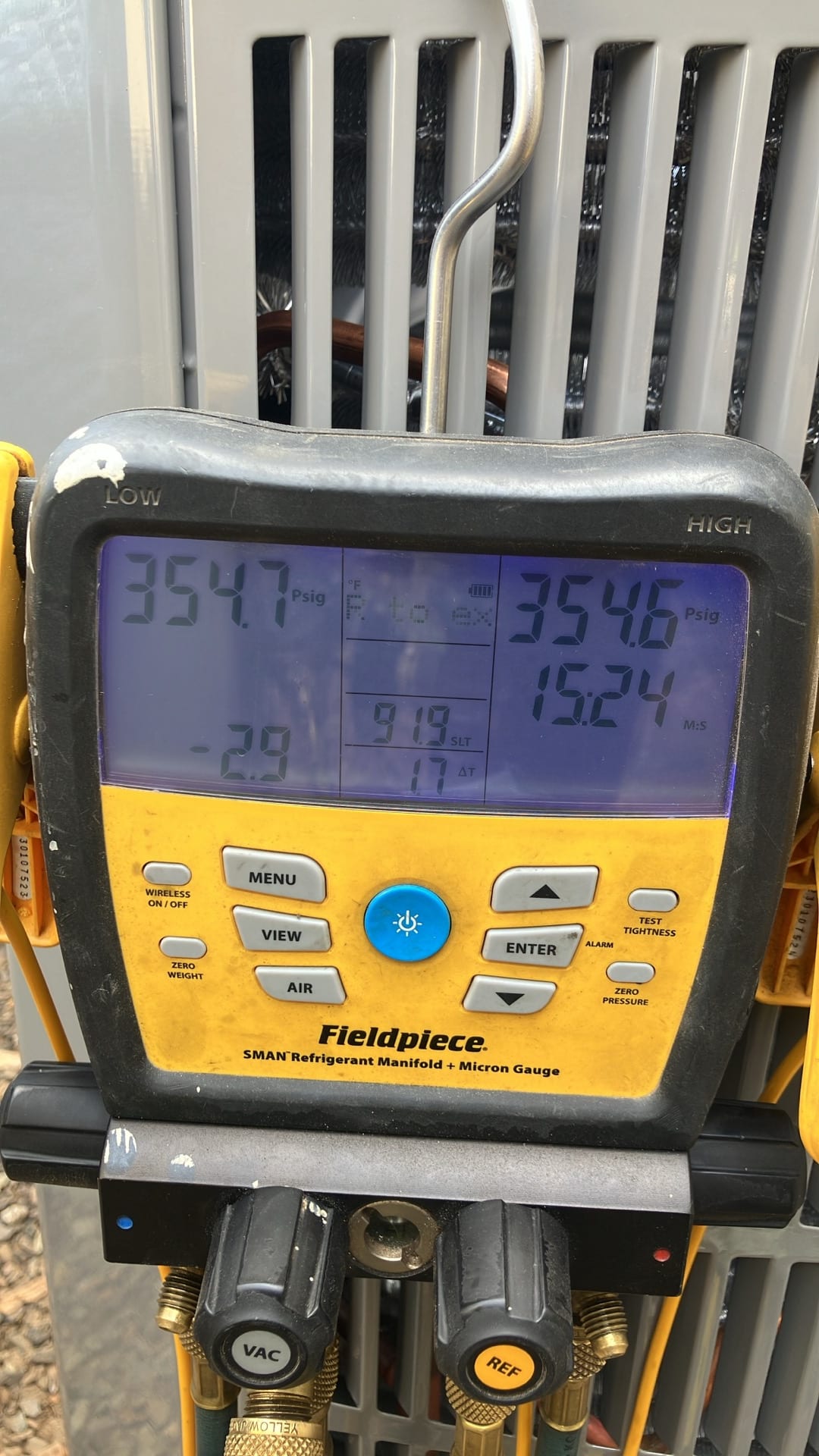 Digital manifold shows both low and high sides holding around 354 PSI, documenting a nitrogen pressure test on the new system.