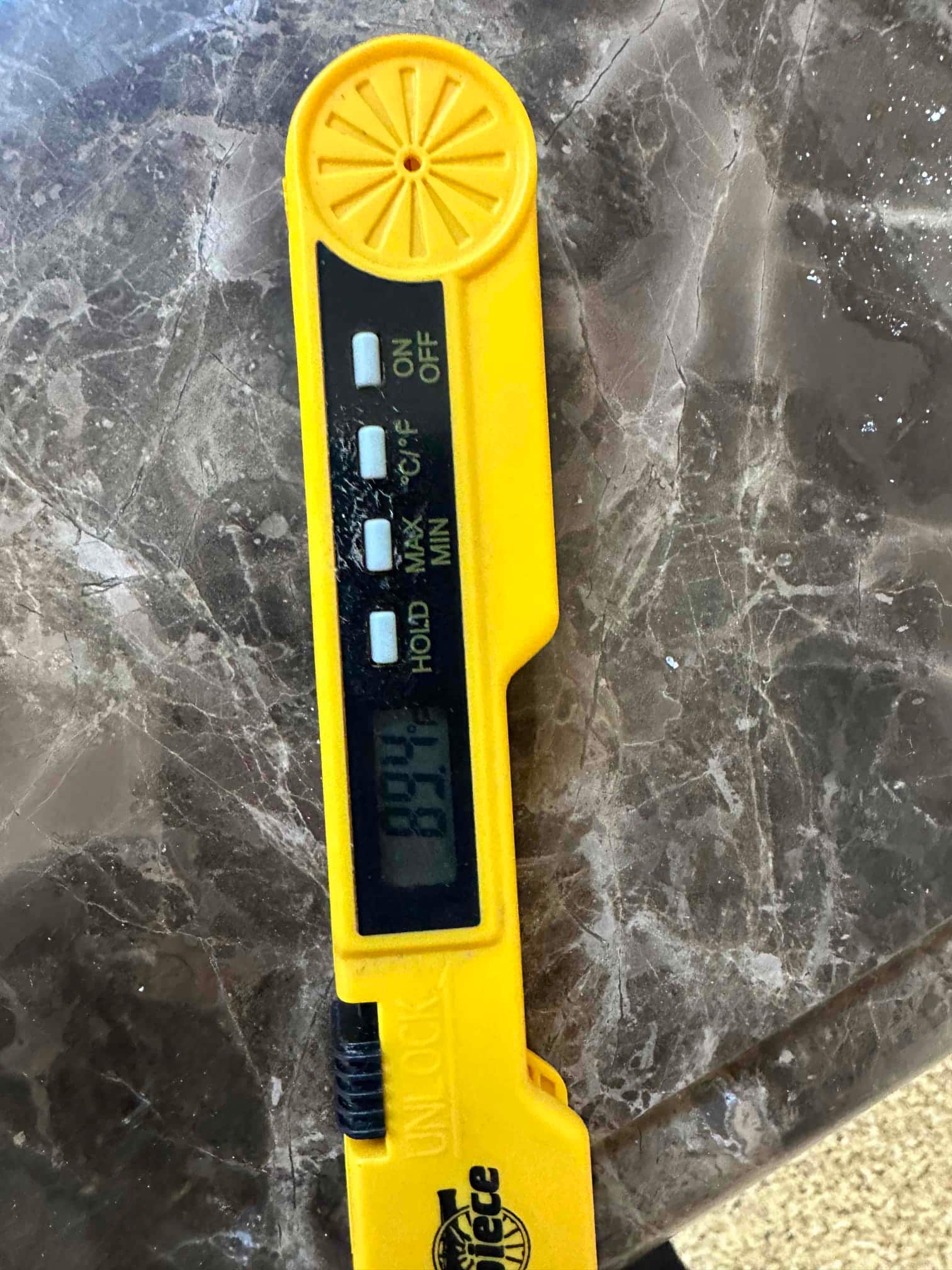 Digital thermometer displays 89°F during air temperature check as part of commissioning measurements.