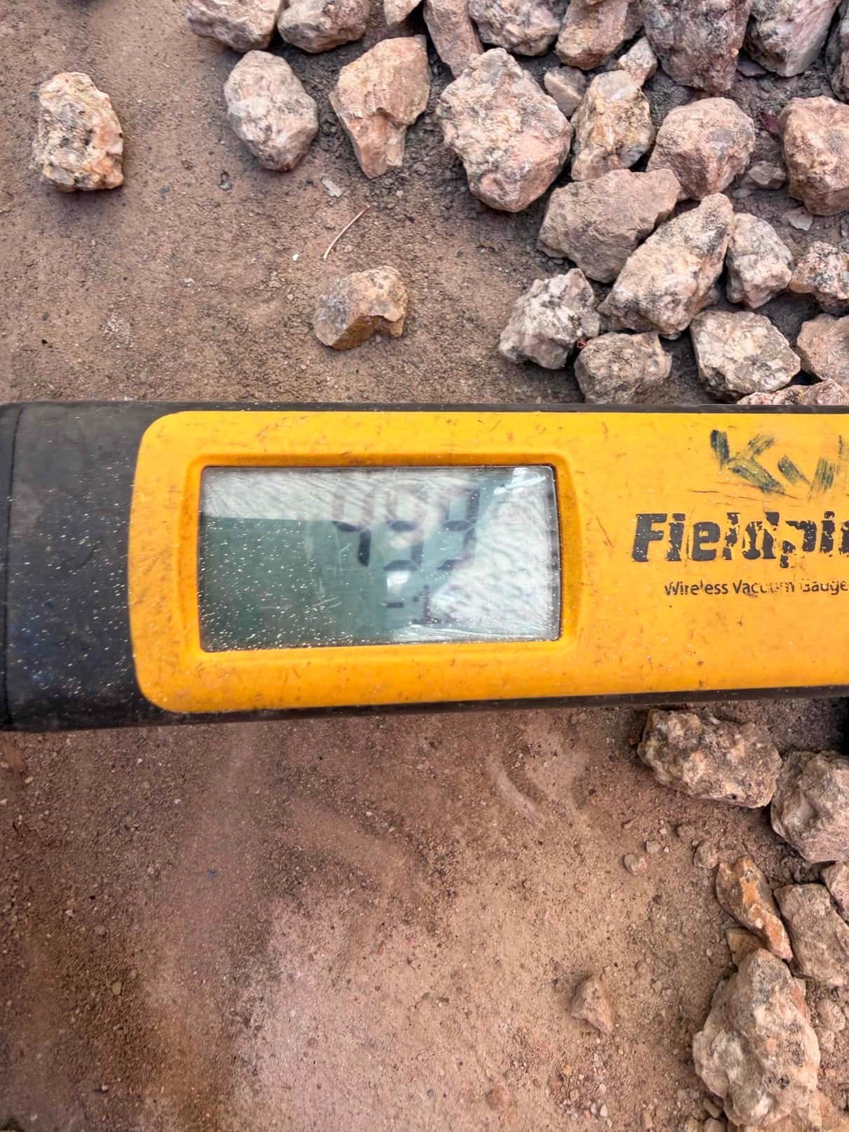 Micron gauge displays 197 microns during evacuation, confirming a deep vacuum before releasing refrigerant into the system.