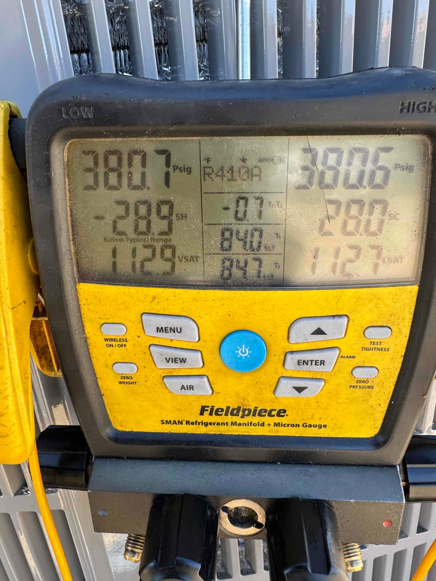 Digital manifold shows both sides holding around 380 PSI, documenting a nitrogen pressure test on the newly installed system.