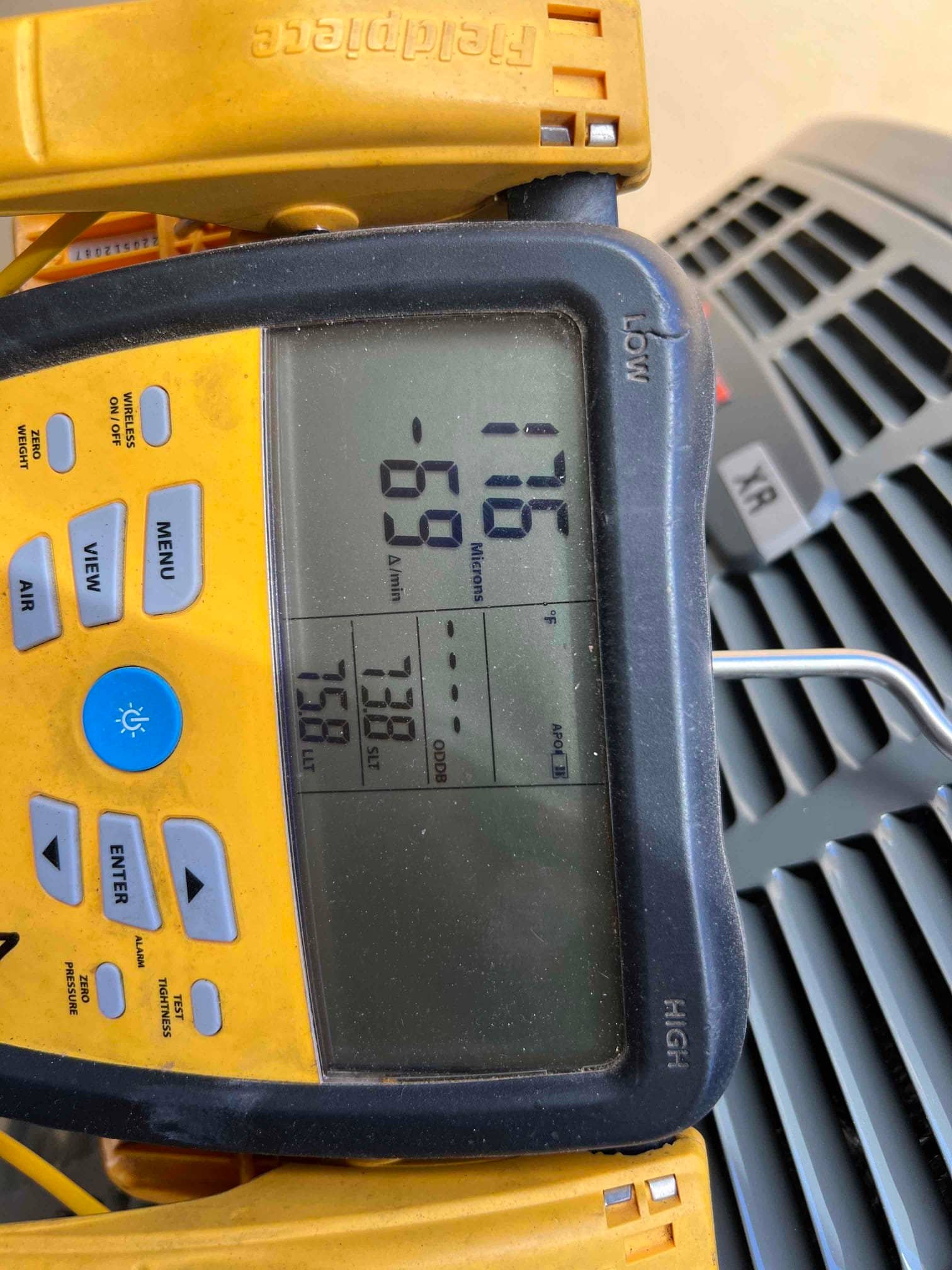 Digital micron gauge shows 176 microns during system evacuation prior to charging the new heat pump.