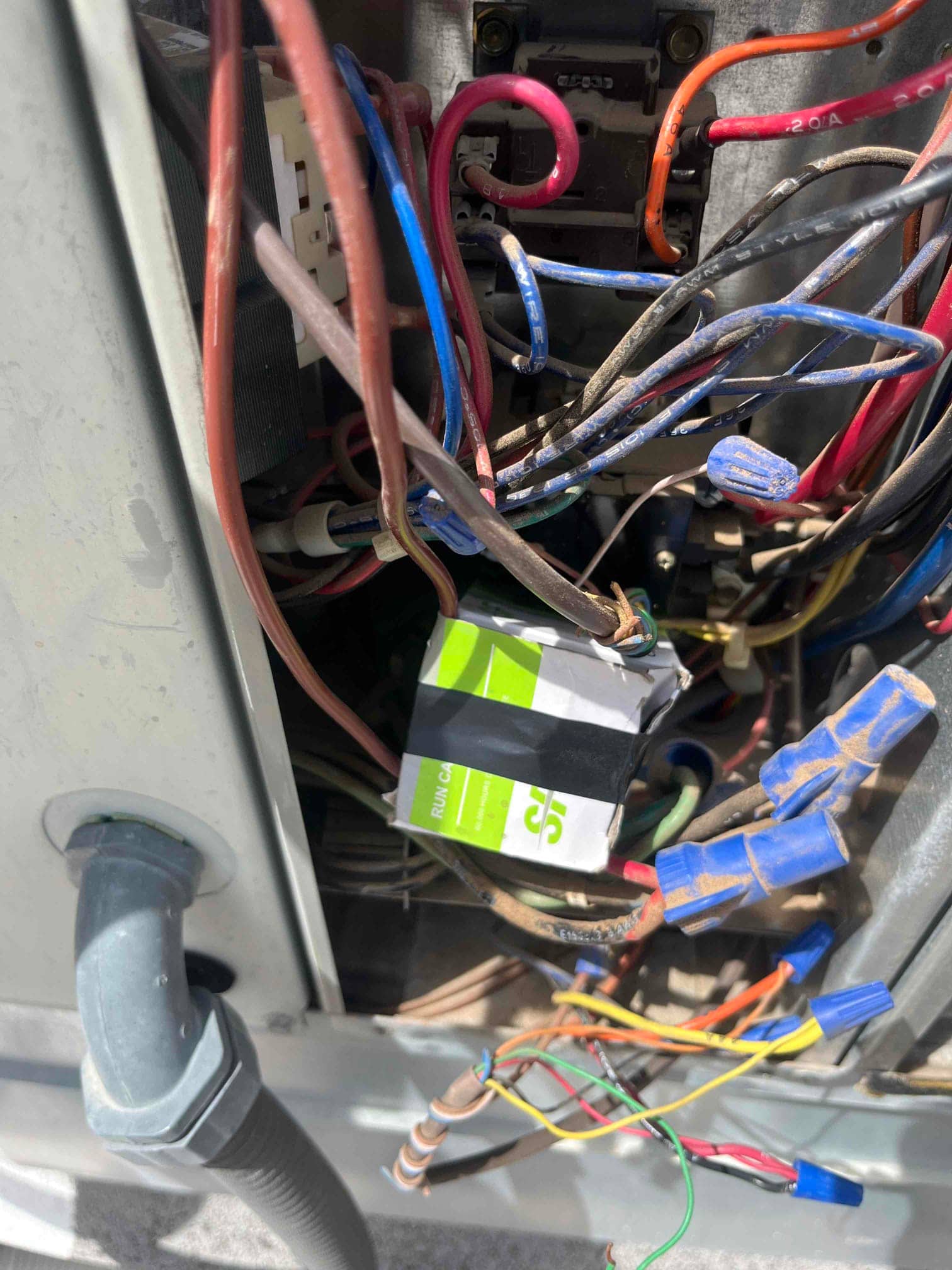 Indoor blower compartment wiring with multiple wire nuts and a replacement run capacitor installed among control wires.