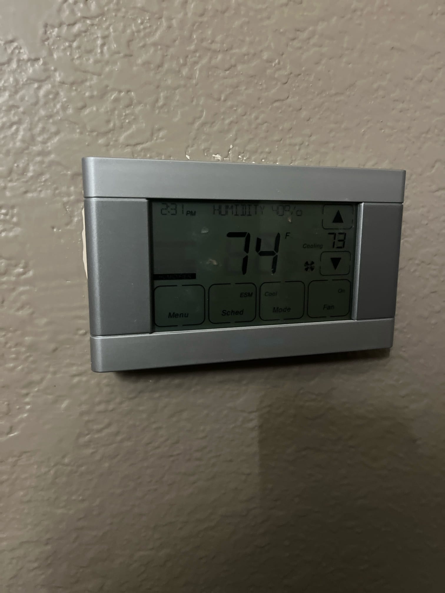 Thermostat display shows indoor temperature at 74°F with cooling setpoint at 73°F and system running.