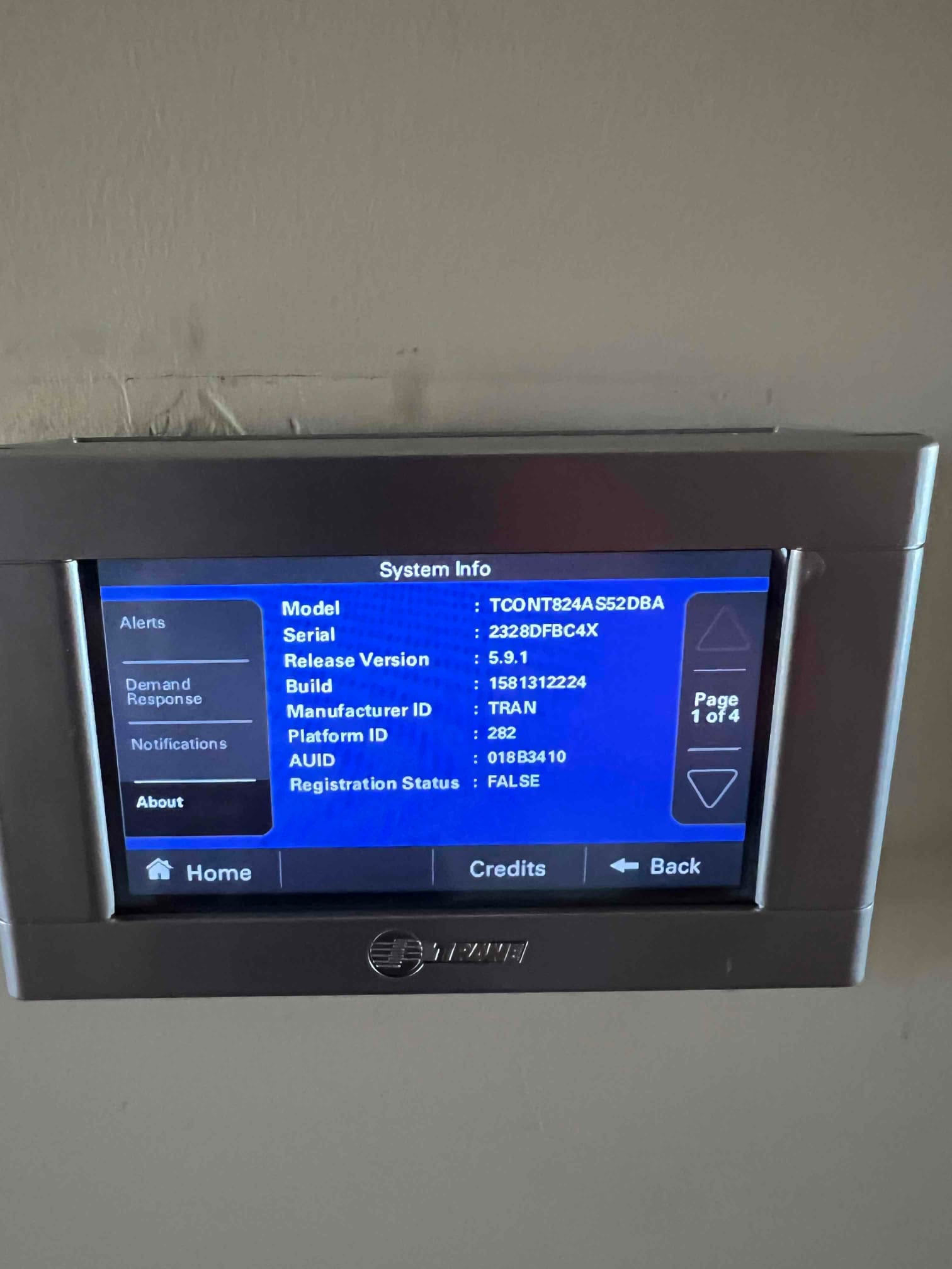Wall-mounted touchscreen thermostat displays system information menu during setup after new HVAC installation.