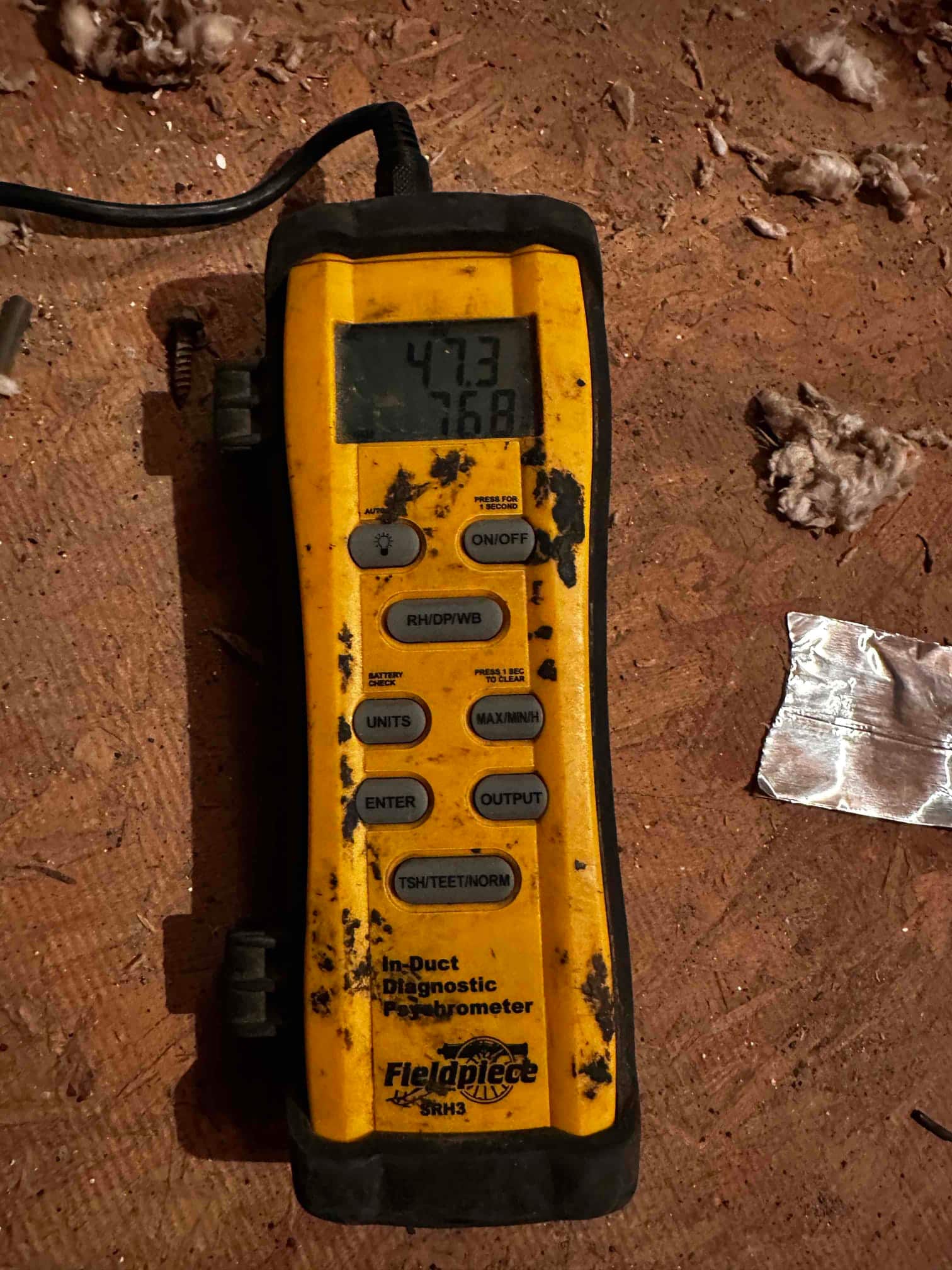 Digital in-duct diagnostic meter displays 76.8 degrees Fahrenheit air temperature during airflow and temperature checks.