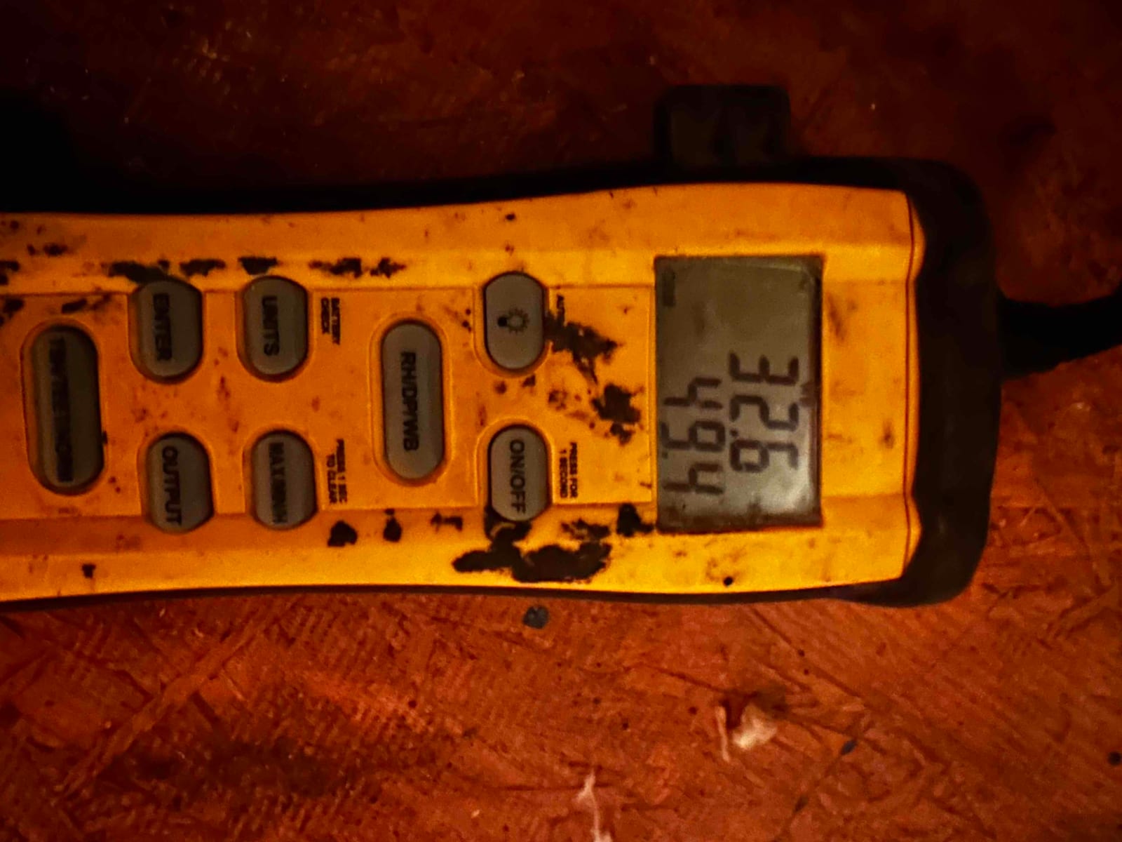 Digital thermometer displays 69.4 degrees Fahrenheit while measuring air temperature during start-up checks.