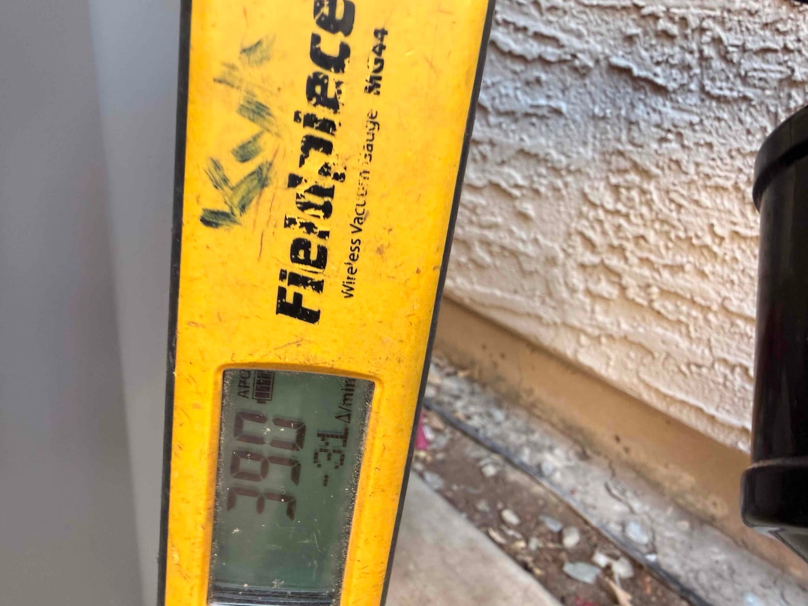 Micron gauge displays 390 microns during system evacuation, confirming a deep vacuum before releasing refrigerant charge.