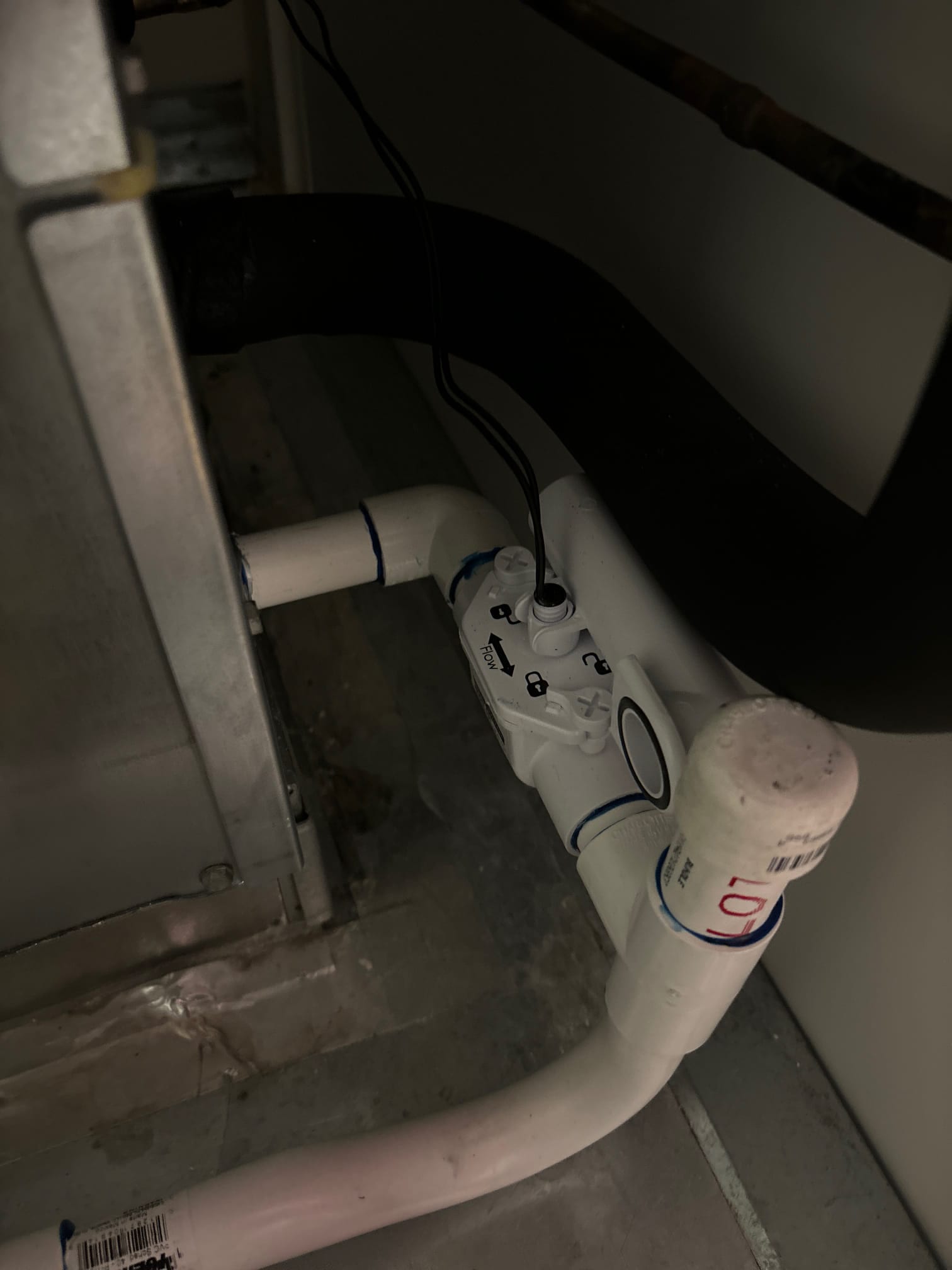 Condensate drain assembly with float safety switch wired in, connected to the air handler and sealed PVC fittings.