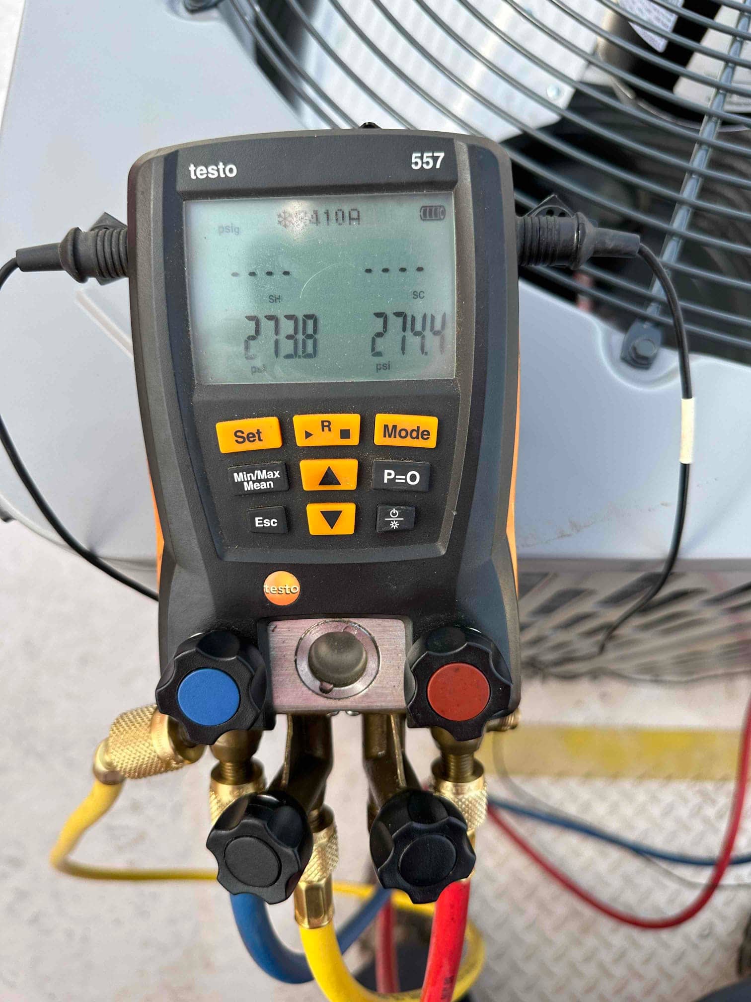 Digital manifold gauges show equal pressures around 274 psi on both sides during a nitrogen pressure test of the system.