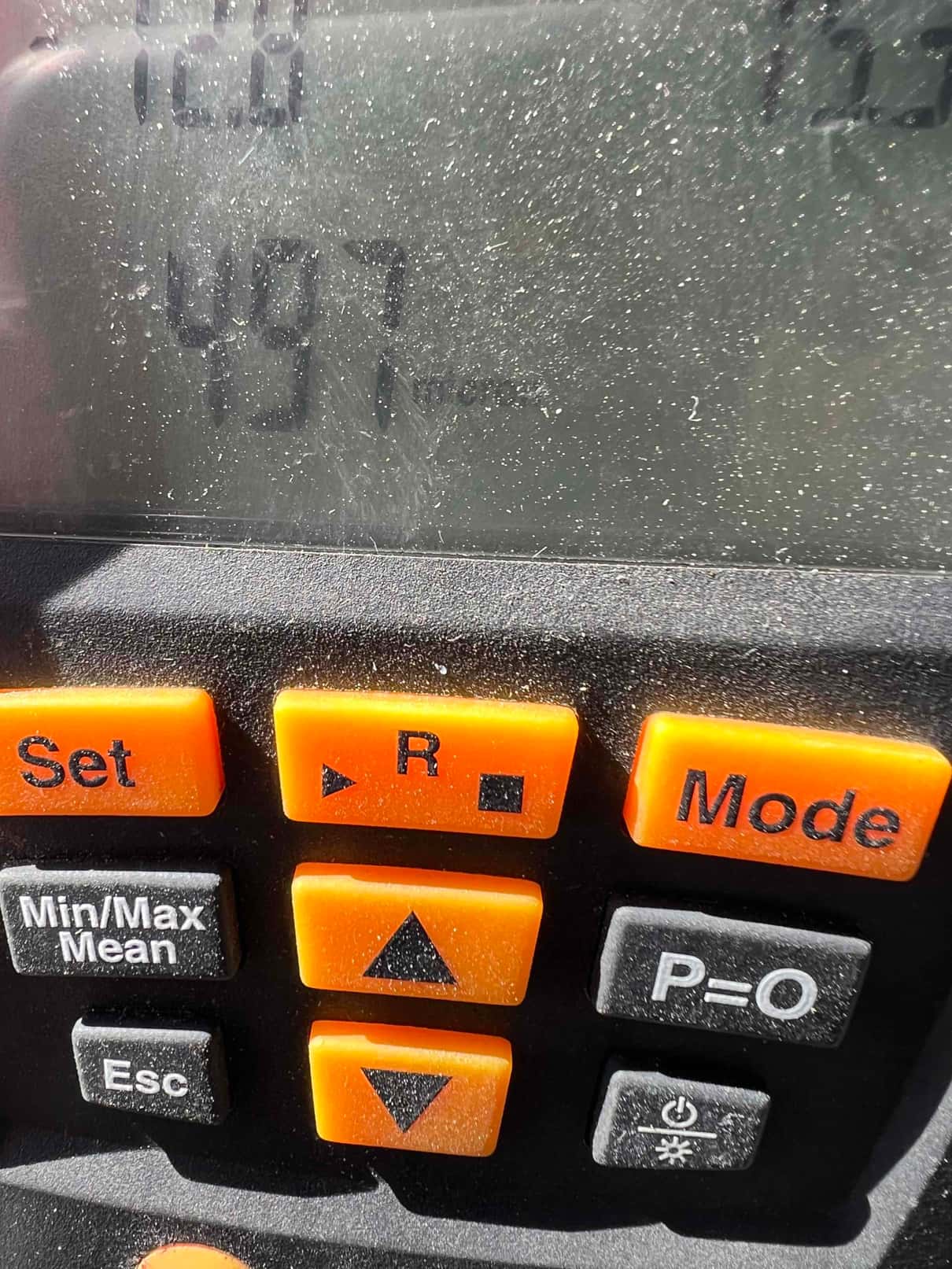 Digital micron gauge display shows 497 microns during evacuation of the refrigeration circuit before charging.