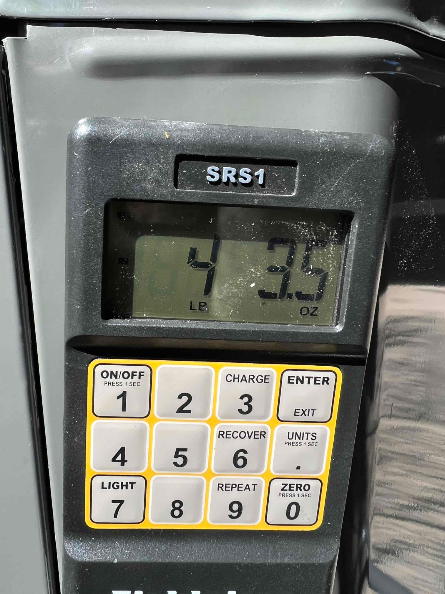 Digital refrigerant scale shows 4 pounds 3.5 ounces during charging as part of commissioning the new system.