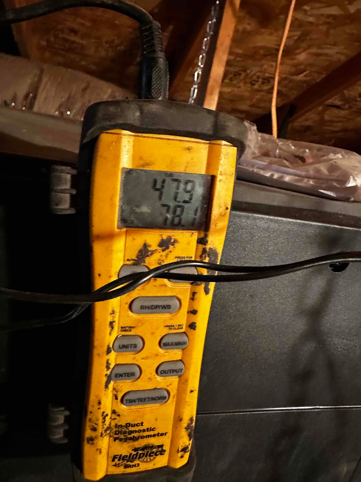 Digital in-duct thermometer displays 47.9 and 78.1 degrees while measuring air temperatures at the air handler.