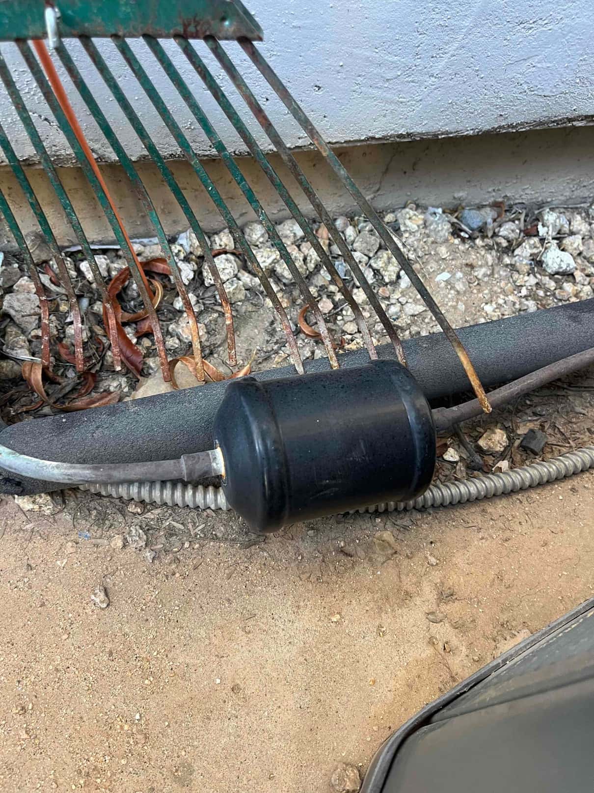 Bi-flow filter drier installed on the refrigerant line outside, with clean brazed connections and intact insulation nearby.