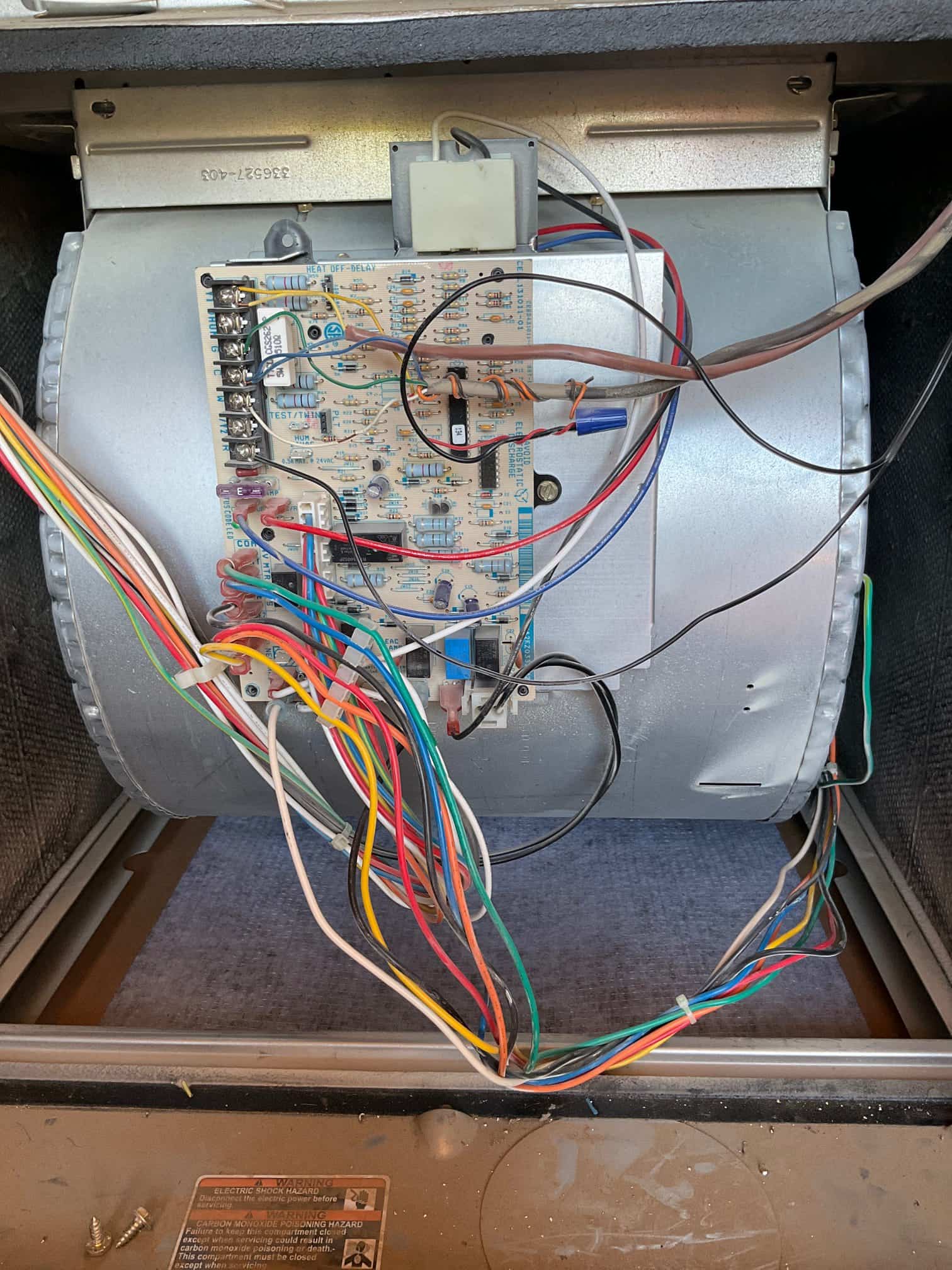 Blower compartment with control board mounted on the blower housing the customer multicolor wiring connected to terminals the customer fuse.