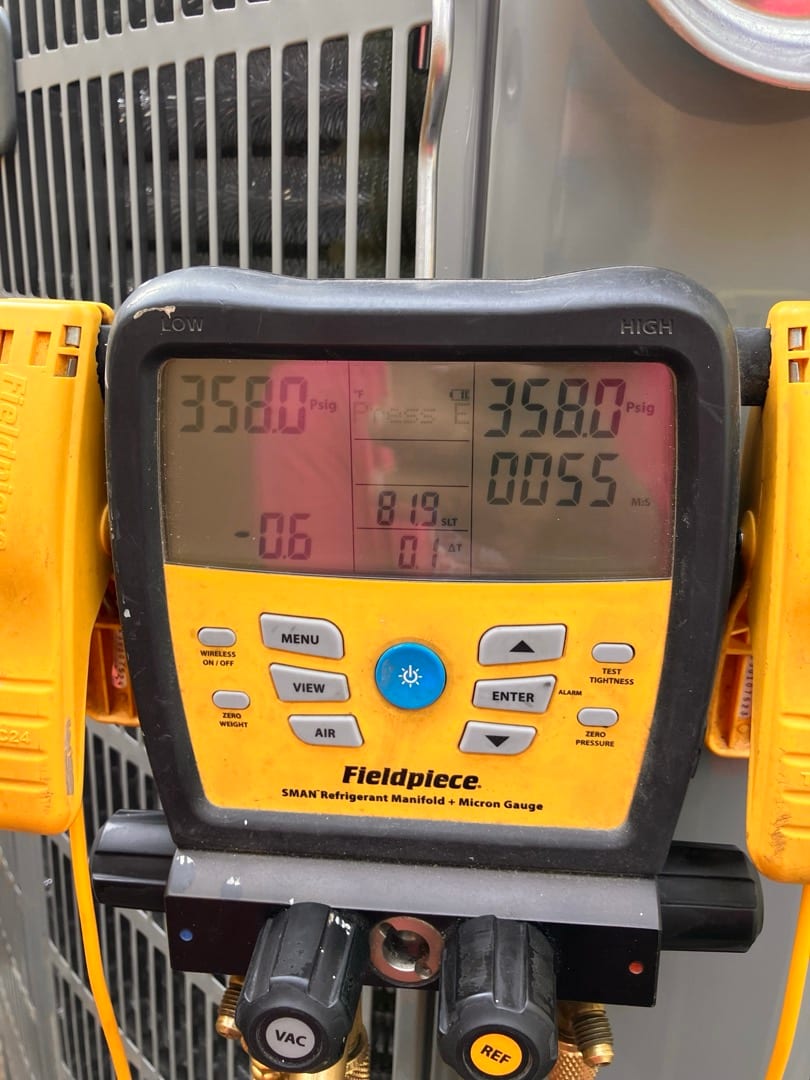Digital manifold gauges show 358 PSI on both high and low sides during a nitrogen pressure test at the outdoor unit.