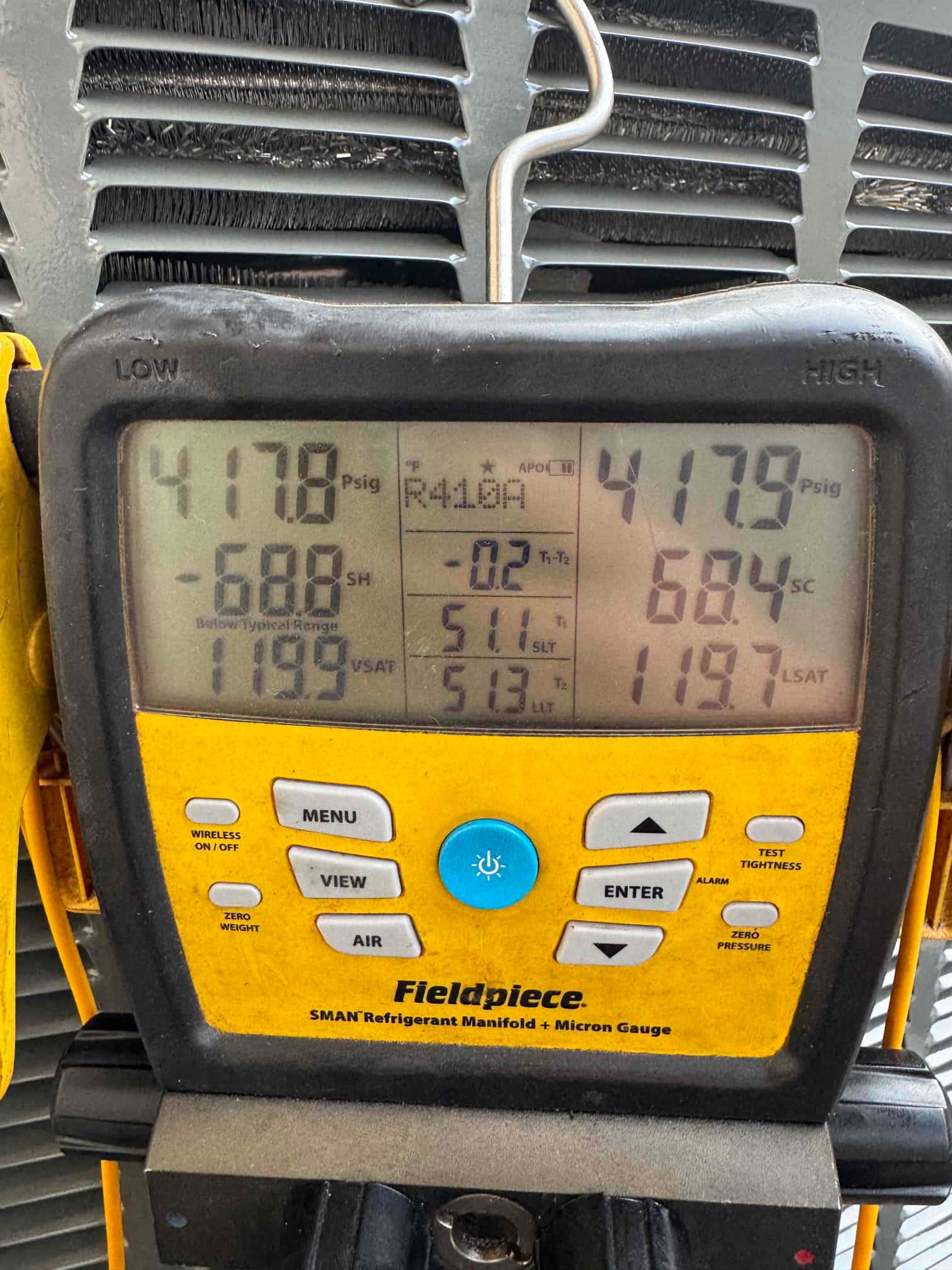 Digital manifold gauges show equal pressure near 418 PSI on both sides during a nitrogen pressure test of the system.